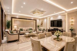 a large living room with a table and a television at Hotel Prak Tree Sector 20 Noida in Noida