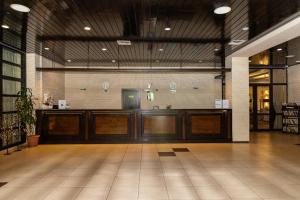 a lobby with wooden doors in a building at Everest Hotel in Etropole