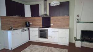 a kitchen with white cabinets and a stove top oven at Apartment Gms in Schottwien