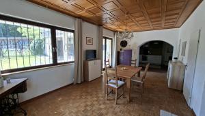 a dining room with a table and chairs and windows at Apartment Gms in Schottwien +12 photos