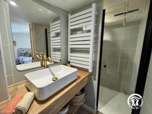 a bathroom with a white sink and a shower at Le carpe diem in Pomas +26 photos