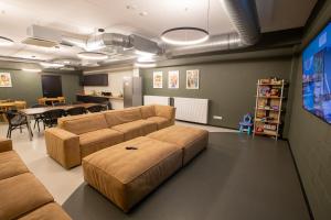 a living room with a couch and a tv at Ring SPA Hostel in Tallinn