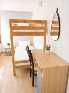 a bedroom with a bunk bed and a desk with a chair at Tabanov Beach Hotel in Sozopol +38 photos