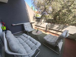 a patio with two chairs and a couch and a table at Apartman-Zara m in Zadar