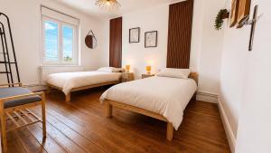 a bedroom with two beds and a window at Maison Luma in Basse-Yutz