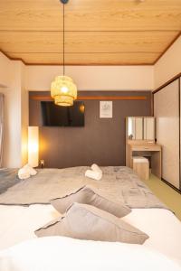 a bedroom with a large bed with a wooden ceiling at CS Residence Chiba in Chiba