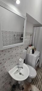a bathroom with a white toilet and a sink at Apartman-Zara m in Zadar +4 photos
