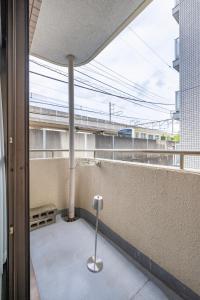 a balcony with a pole in the middle of a building at CS Residence Chiba in Chiba
