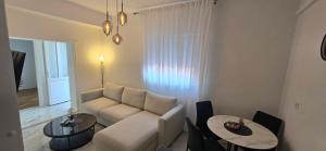 a living room with a couch and a table at Apartman-Zara m in Zadar