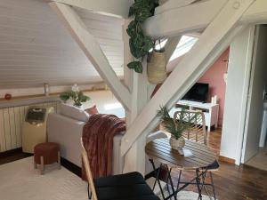 a living room with a couch and a table at Maison le baron in Bélus