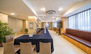 a conference room with a long table and chairs at Dongdaegu Station Eastern Hotel in Daegu