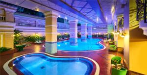 a large swimming pool in a building with a swimming poolvisor at Sherwood Residence in Ho Chi Minh City