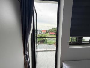 a room with a window with a view of a pool at The Haven Motel in Chú Cư
