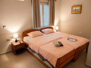 a bedroom with a large bed and a window at Villa Stefan Ohrid in Ohrid
