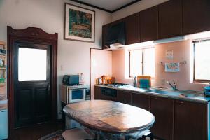 a small kitchen with a table and a sink at Kacho-en / Vacation STAY 1048 in Mitoyo