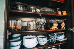 a shelf filled with plates and glasses and other dishes at Kacho-en / Vacation STAY 1048 in Mitoyo +14 photos