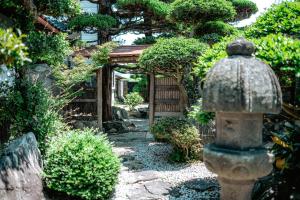 a garden with a fire hydrant in the yard at Kacho-en / Vacation STAY 1048 in Mitoyo