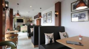 a living room with a table and a dining room at Citytel Inn in Beijing