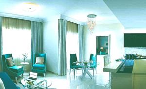 a living room with a table and a dining room at Hotel- M8 in Kota