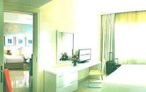 a bedroom with a bed and a desk with a window at Hotel- M8 in Kota