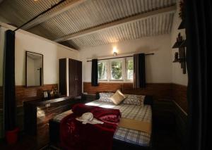 a small bedroom with a bed and a window at The Chill Inn ''Families Only'' By Green Leaves in Ooty +28 photos