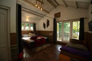 a living room with a couch and a window at The Chill Inn ''Families Only'' By Green Leaves in Ooty