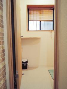 an empty room with a window and a shelf at HOTEL LUCKY / Vacation STAY 4266 in Osaka