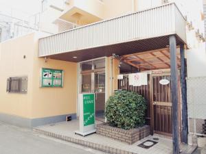 a store front with a green sign in front of it at HOTEL LUCKY / Vacation STAY 4266 in Osaka