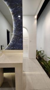 a bathroom with a marble counter and a sink at Bnaya Villas Riverside in Amed +29 photos