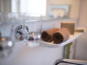 a shelf with towels on a sink in a bathroom at Stuttgart Großbettlingen Hotel by Belvilla in Großbettlingen +52 photos