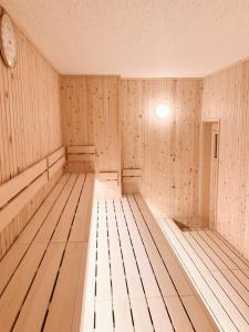 an empty wooden room with a clock on the wall at Hakodate - Hotel / Vacation STAY 34006 in Hakodate
