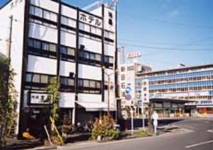a building with a person standing in front of it at Komecho Ryokan / Vacation STAY 36247 in Imabari