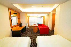 a hotel room with two beds and a red chair at Hashima - Hotel - Vacation STAY 52815v in Hashima +12 photos