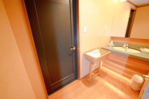 a bathroom with a sink and a mirror and a door at Hashima - Hotel - Vacation STAY 52664v in Hashima +7 photos