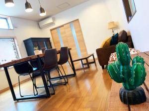 a living room with a table and chairs and a cactus at Cactus Inn / Vacation STAY 51549 in Miyazaki