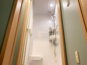 a small bathroom with a toilet and a shower at Cactus Inn / Vacation STAY 51549 in Miyazaki +19 photos