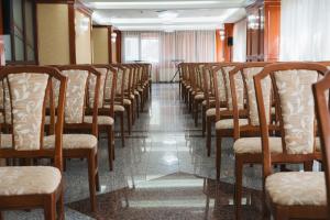 a row of chairs lined up in a room at Hotel Emma Est in Craiova