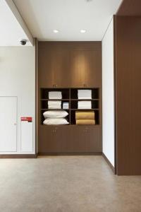 a room with a closet with folded towels at Hotel Sun Clover Koshigaya Station - Vacation STAY 55366 in Koshigaya +16 photos