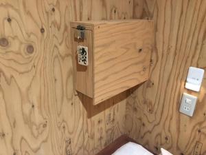a wood paneled bathroom with a wooden wall at Guesthouse Otaru Wanokaze women's domitory / Vacation STAY 32191 in Otaru