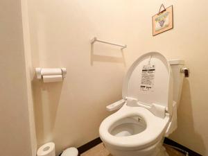 a bathroom with a toilet with the lid up at Guesthouse Otaru Wanokaze women's domitory / Vacation STAY 32191 in Otaru +23 photos