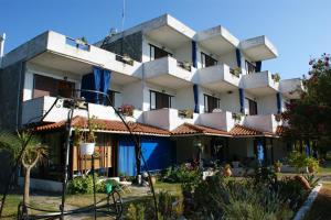 a building with balconies and plants in a garden at Villa Iris Studios in Ormos Panagias