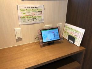 a computer monitor sitting on a desk in a room at Time - Vacation STAY 18889v in Kagoshima
