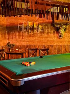 a pool table in a bar with a green at AIRIS Residence in Almaty