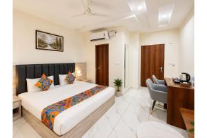 a hotel room with a bed and a desk at FabHotel K9 Regency in Zirakpur