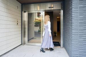 a woman is standing outside of a building at Time - Vacation STAY 18884v in Kagoshima