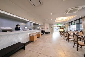 a restaurant with a woman sitting at a counter at Main Hotel - Vacation STAY 60535v in Miyakonojō