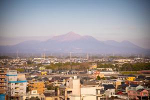 a view of a city with a mountain in the background at Main Hotel - Vacation STAY 60535v in Miyakonojō