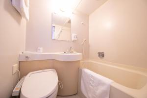 a bathroom with a toilet and a sink and a tub at Main Hotel - Vacation STAY 82545 in Miyakonojō +8 photos