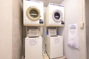 three washing machines on a shelf in a room at Main Hotel - Vacation STAY 82545 in Miyakonojō