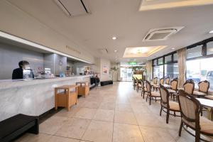 a restaurant with tables and chairs and a counter at Main Hotel - Vacation STAY 82545 in Miyakonojō